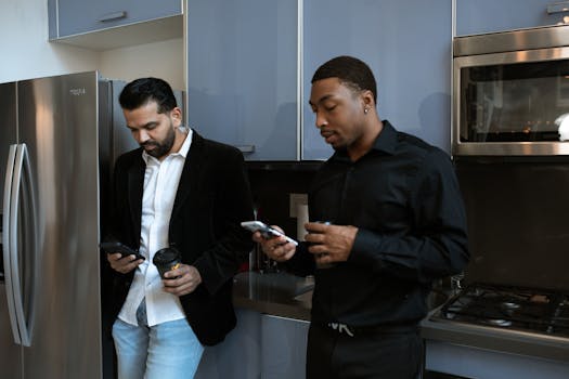 Man in Black Dress Shirt Holding Smartphone